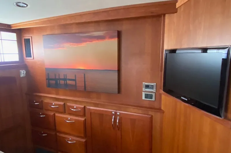 Slide: The Image of Interior of 2012 Sabre 48 Salon Express with wood cabinetry and wall art. - 38