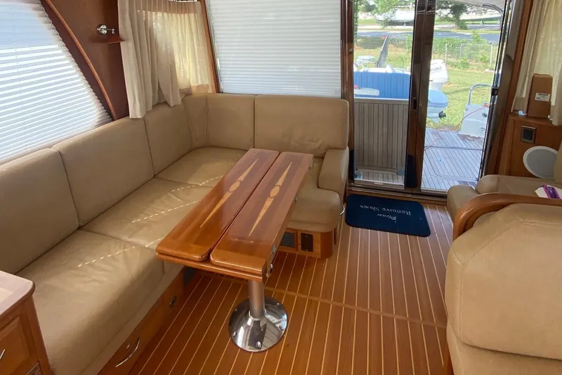 Slide: The Image of Luxurious interior of 2012 Sabre 48 Salon Express yacht with beige seating and wooden table. - 42