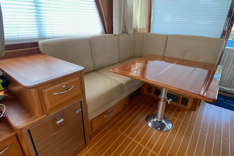 Slide: The Image of 2012 Sabre 48 Salon Express interior with beige seating and wooden table. - 43