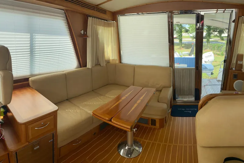 Slide: The Image of Interior of 2012 Sabre 48 Salon Express with beige seating and wooden table. - 44