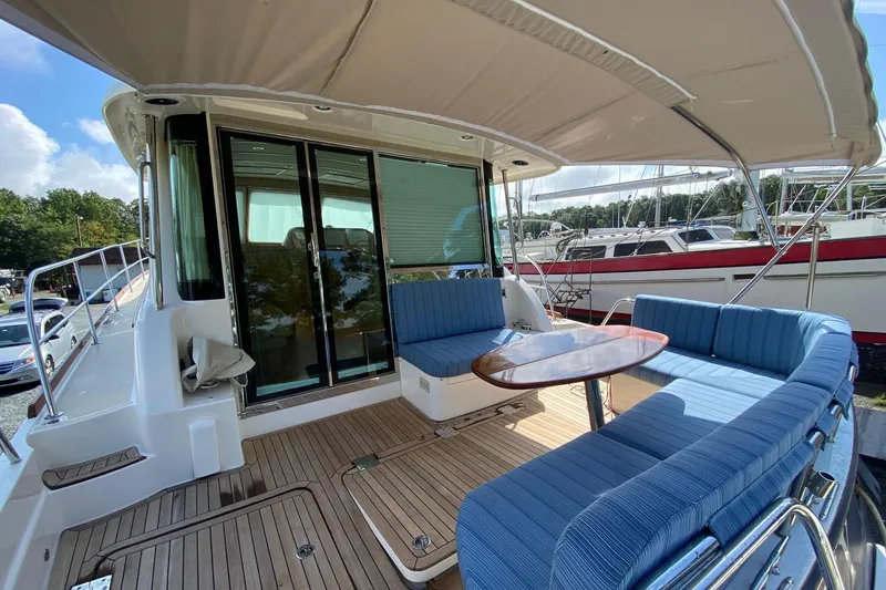 Slide: The Image of 2012 Sabre 48 Salon Express yacht with blue seating and wooden deck. - 47