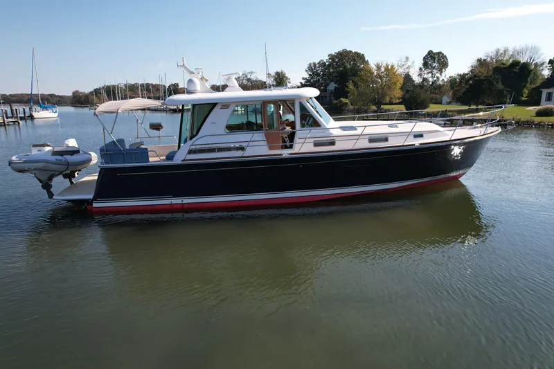 Slide: The Image of 2012 Sabre 48 Salon Express yacht on calm water, side view. - 49