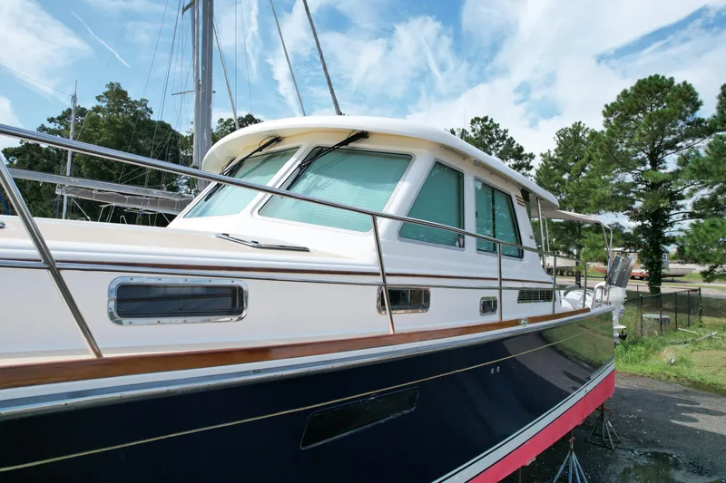 Slide: The Image of 2012 Sabre 48 Salon Express yacht with sleek design, docked outdoors. - 6