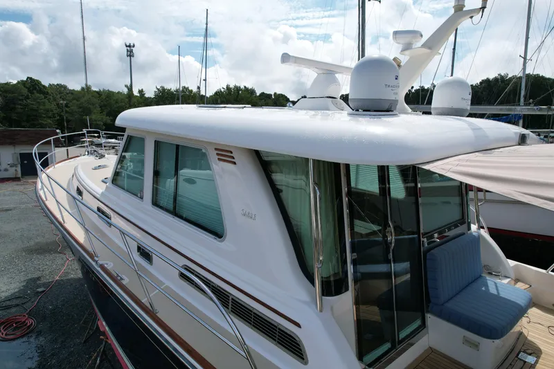 Slide: The Image of 2012 Sabre 48 Salon Express yacht docked, showcasing sleek design and modern features. - 7