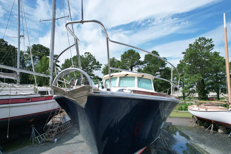 Slide: The Image of 2012 Sabre 48 Salon Express yacht on land, surrounded by trees and other boats. - 8