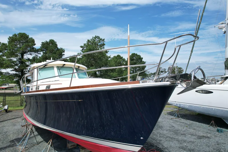 Slide: The Image of 2012 Sabre 48 Salon Express boat on land, blue hull, clear sky background. - 9