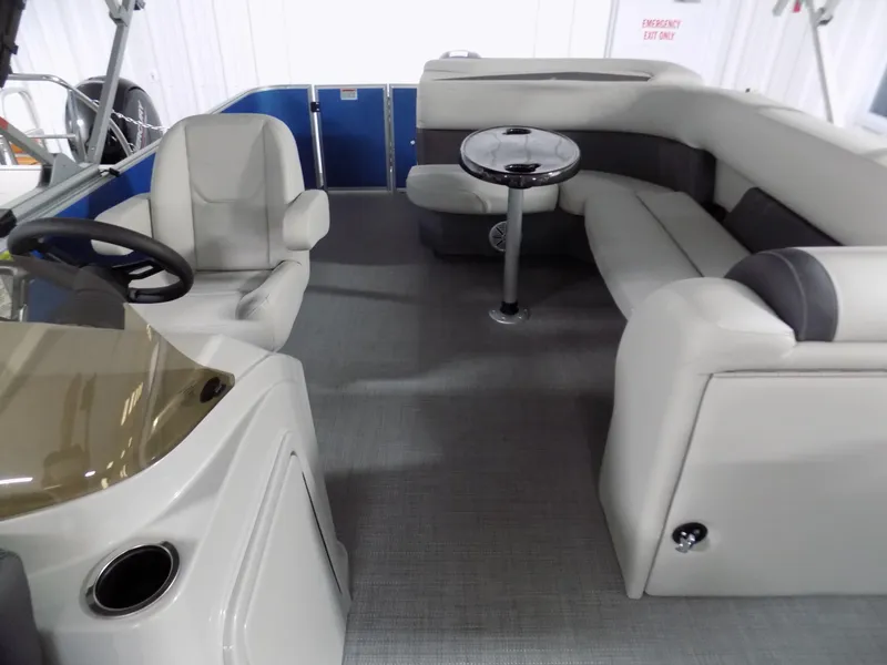 Slide: The Image of 2024 Sylvan 8522 Mirage Cruise interior with captain's chair and lounge seating. - 2