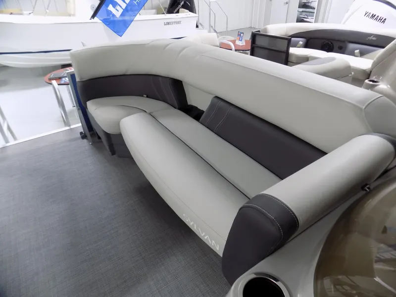 Slide: The Image of 2024 Sylvan 8522 Mirage Cruise boat interior seating with gray and black upholstery. - 8