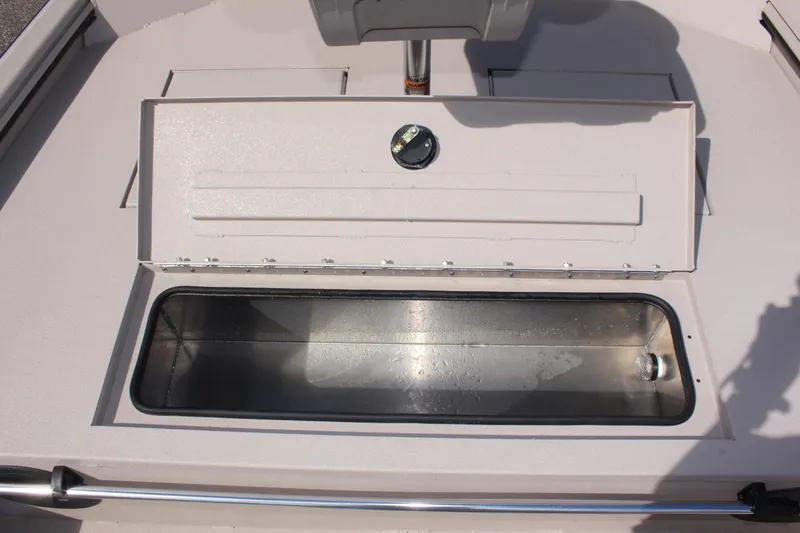 Slide: The Image of 2024 Avid 18 Rogue boat storage compartment with open lid. - 12