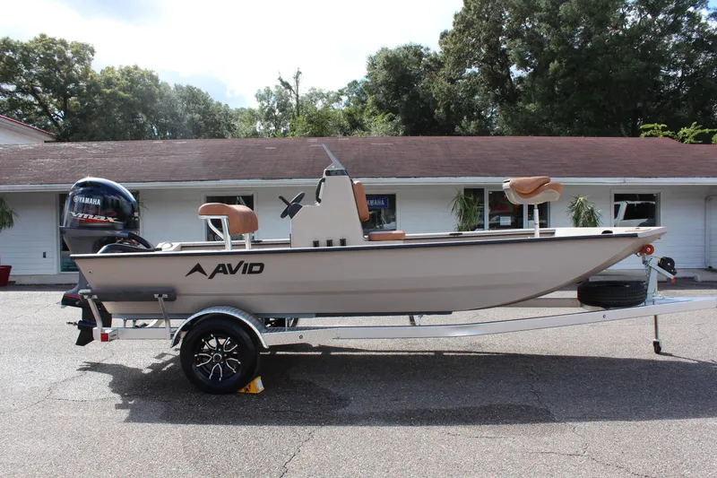 Slide: The Image of 2024 Avid 18 Rogue boat on trailer, side view, outdoors. - 4