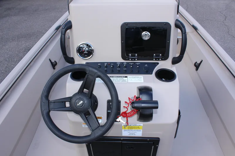 Slide: The Image of 2024 Avid 18 Rogue boat console with steering wheel and control panel. - 8