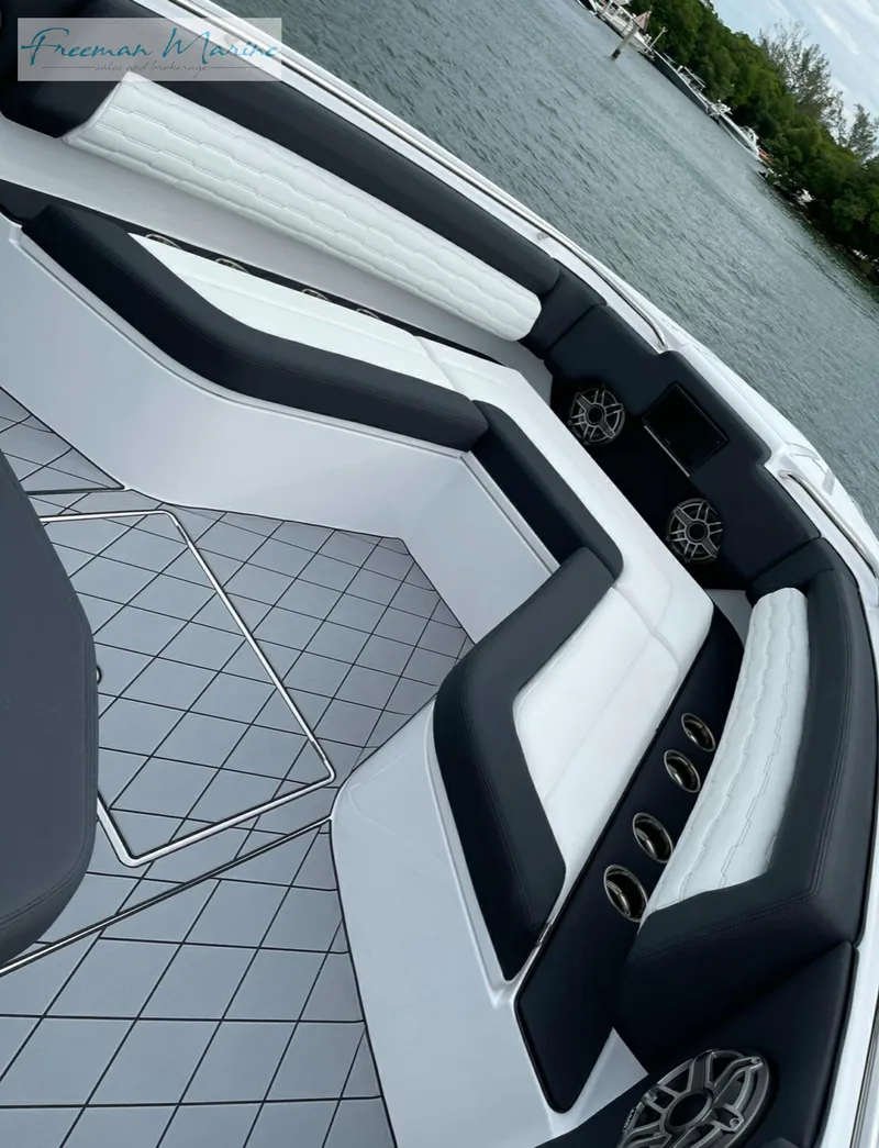 Slide: The Image of 2021 Cigarette 41 Nighthawk boat interior with black and white seating, on a calm water body. - 13