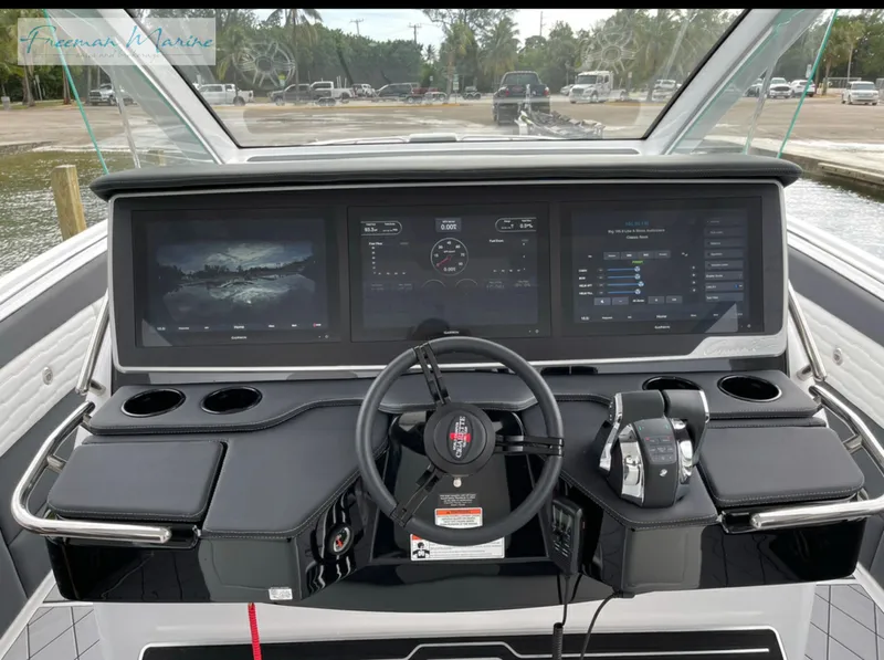 Slide: The Image of 2021 Cigarette 41 Nighthawk boat dashboard with advanced navigation screens and controls. - 21