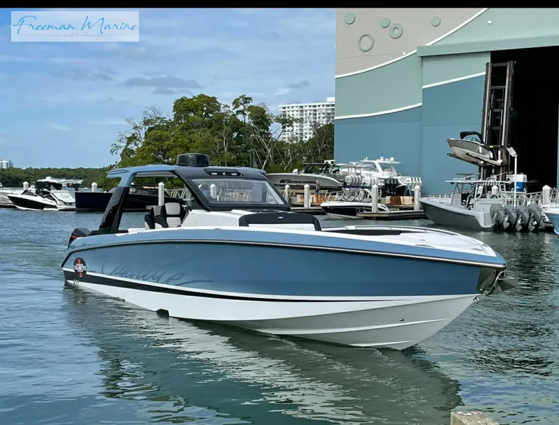 Slide: The Image of 2021 Cigarette 41 Nighthawk boat docked near marina with Freeman Marine sign. - 22