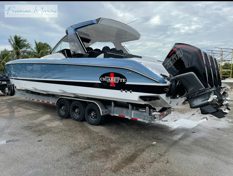 Slide: The Image of 2021 Cigarette 41 Nighthawk boat on trailer with triple outboard engines. - 3