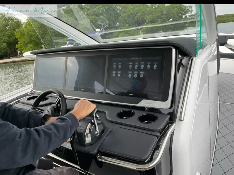 Slide: The Image of 2021 Cigarette 41 Nighthawk dashboard with touchscreen controls and steering wheel. - 9