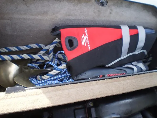 Slide: The Image of Storage compartment in a 2001 Malibu VLX with life jackets and rope. - 13
