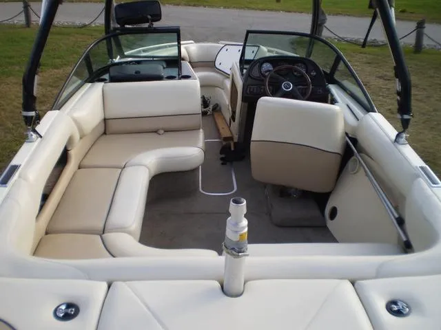 Slide: The Image of 2001 Malibu VLX boat interior with beige seating and steering console. - 4