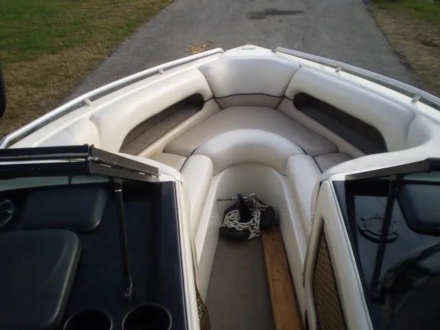 Slide: The Image of 2001 Malibu VLX boat interior with white cushioned seating. - 6