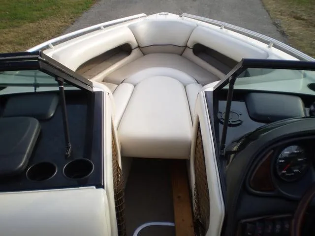 Slide: The Image of 2001 Malibu VLX boat interior with white cushioned seating and cup holders. - 7