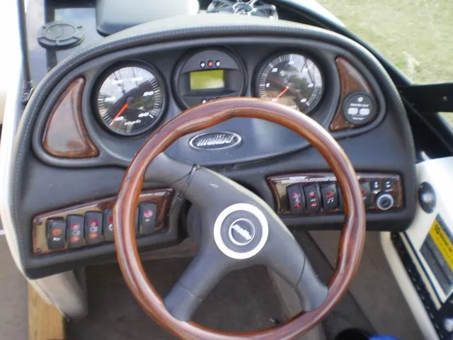 Slide: The Image of 2001 Malibu VLX boat dashboard with steering wheel and control gauges. - 8