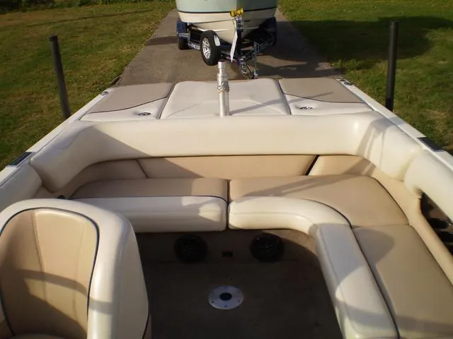 Slide: The Image of 2001 Malibu VLX boat interior with beige seating and trailer in background. - 9