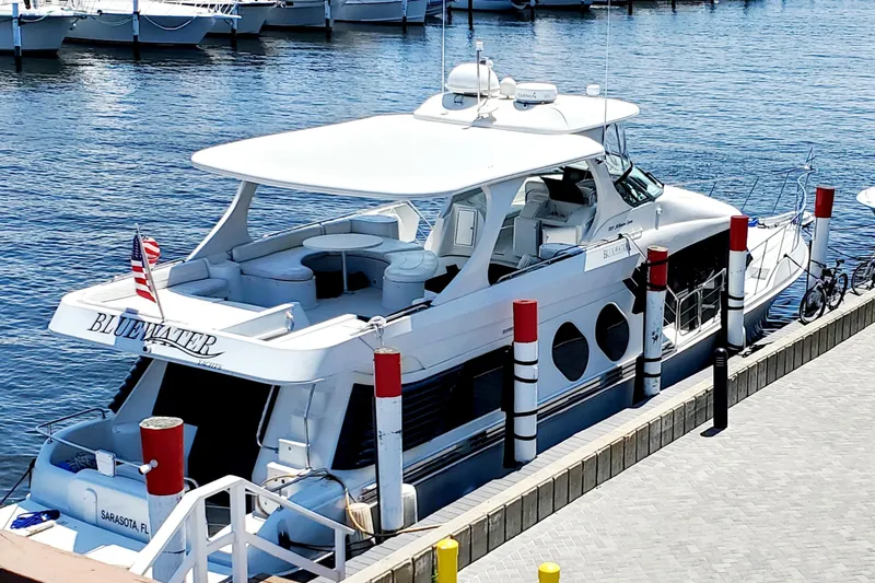 Slide: The Image of 2000 Bluewater Yachts 5800 Motor Yacht docked in a marina on a sunny day. - 13