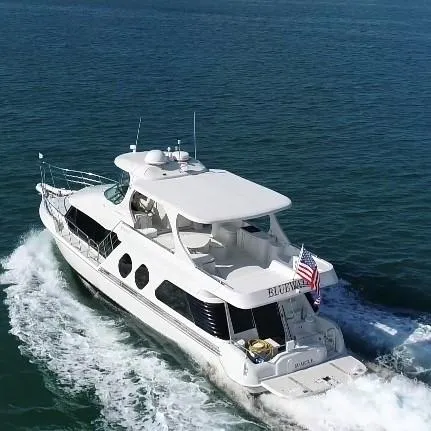 Slide: The Image of Bluewater Yachts 5800 Motor Yacht 2000 docked at night with blue and purple lights. - 16