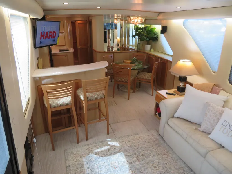 Slide: The Image of Interior of 2000 Bluewater Yachts 5800 Motor Yacht with modern furnishings and cozy seating area. - 19