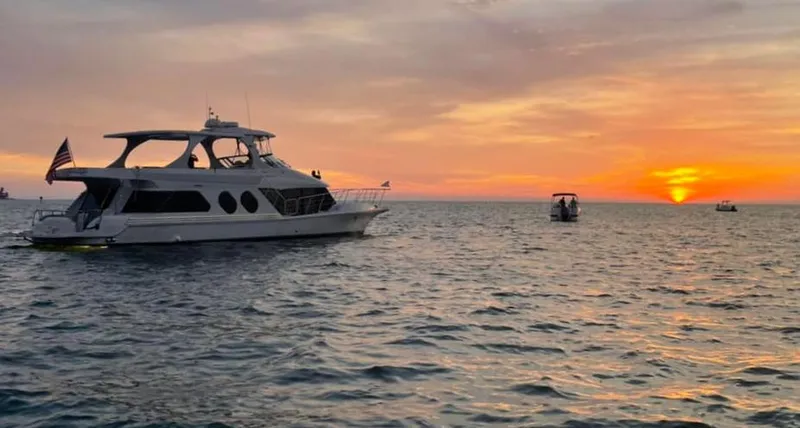 Slide: The Image of Bluewater Yachts 5800 Motor Yacht, 2000, cruising at sunset on calm waters. - 2