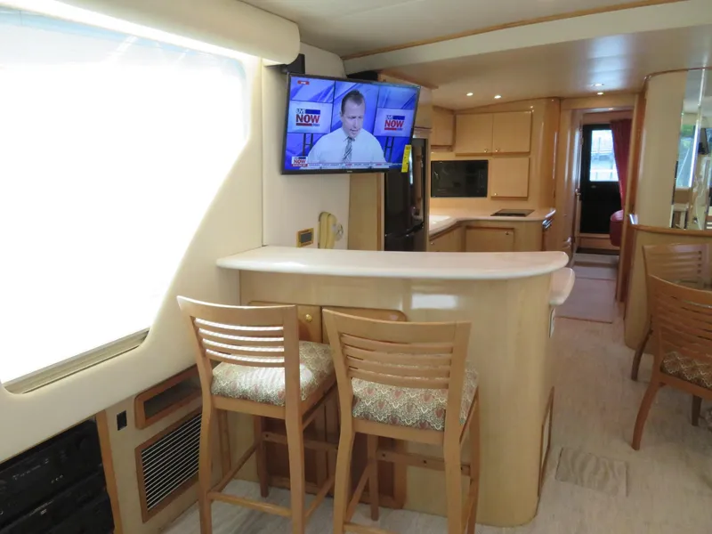 Slide: The Image of Interior of 2000 Bluewater Yachts 5800 Motor Yacht with bar stools and TV. - 20