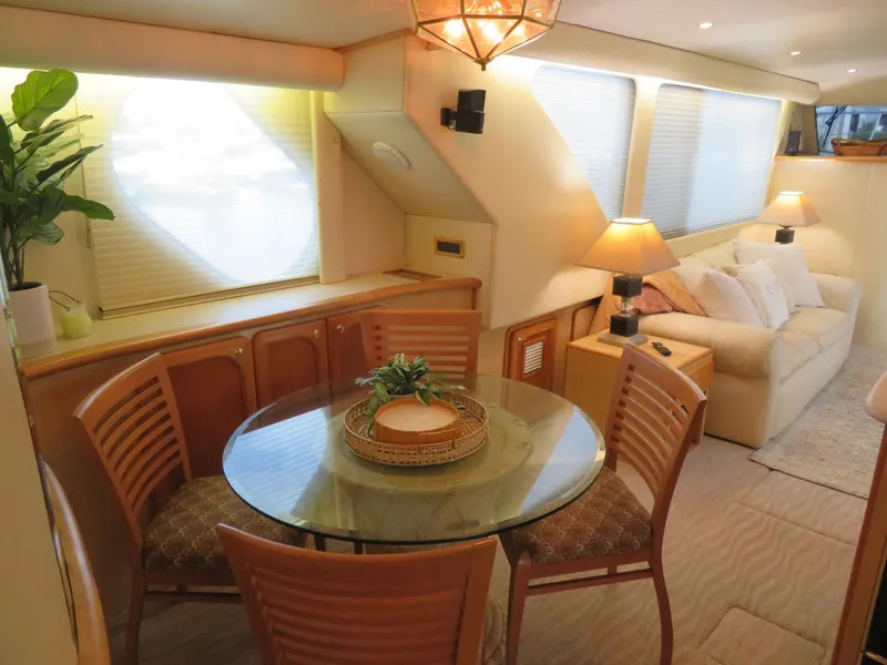 Slide: The Image of Interior of 2000 Bluewater Yachts 5800 Motor Yacht with dining area and cozy seating. - 23