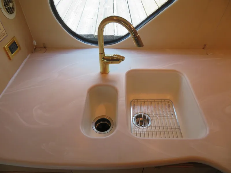 Slide: The Image of 2000 Bluewater Yachts 5800 Motor Yacht kitchen sink with gold faucet. - 31