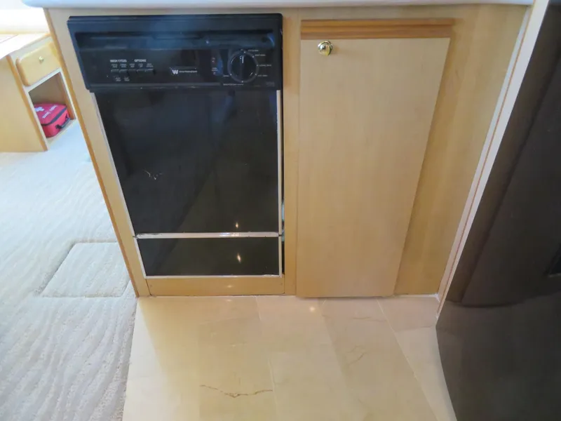 Slide: The Image of Kitchen area of a 2000 Bluewater Yachts 5800 Motor Yacht with dishwasher and cabinet. - 34