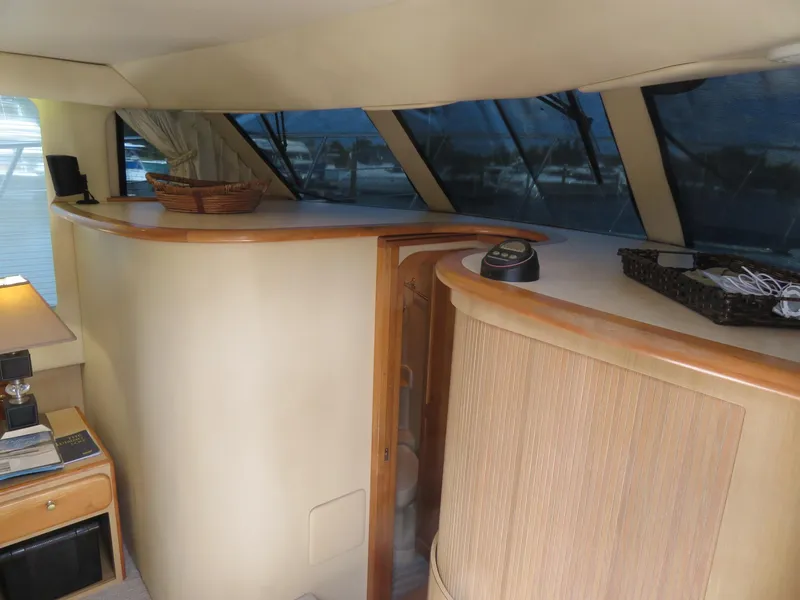 Slide: The Image of Interior of 2000 Bluewater Yachts 5800 Motor Yacht with wooden cabinetry and large windows. - 36
