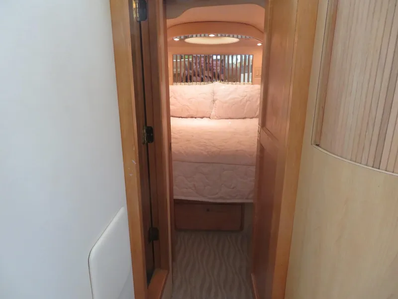 Slide: The Image of 2000 Bluewater Yachts 5800 Motor Yacht bedroom with cozy bed and wooden interior. - 38