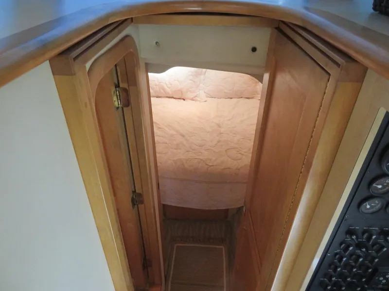 Slide: The Image of Interior cabin view of 2000 Bluewater Yachts 5800 Motor Yacht with wooden door and cozy bed. - 39