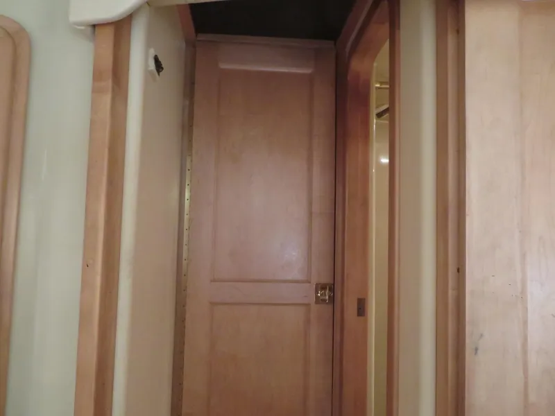 Slide: The Image of Interior hallway of 2000 Bluewater Yachts 5800 Motor Yacht with wooden doors. - 42