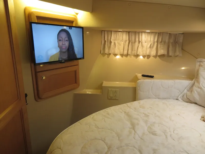 Slide: The Image of 2000 Bluewater Yachts 5800 Motor Yacht bedroom with TV and cozy bed. - 48