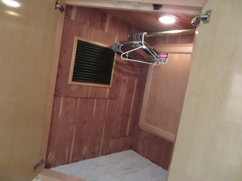 Slide: The Image of Wooden closet interior on a 2000 Bluewater Yachts 5800 Motor Yacht. - 49