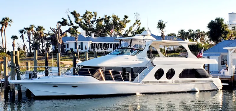 Slide: The Image of 2000 Bluewater Yachts 5800 Motor Yacht docked at marina during sunset. - 5