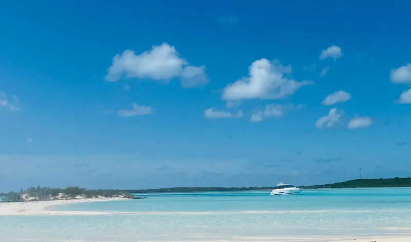 Slide: The Image of 2023 Regal 36 XO yacht cruising in clear blue tropical waters under a bright sky. - 13