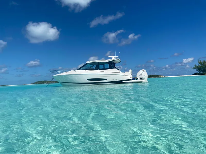 Slide: The Image of 2023 Regal 36 XO boat on clear turquoise water under blue sky. - 16