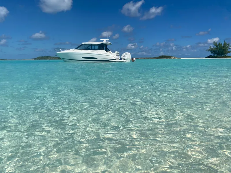 Slide: The Image of 2023 Regal 36 XO boat on clear turquoise water under blue sky. - 17