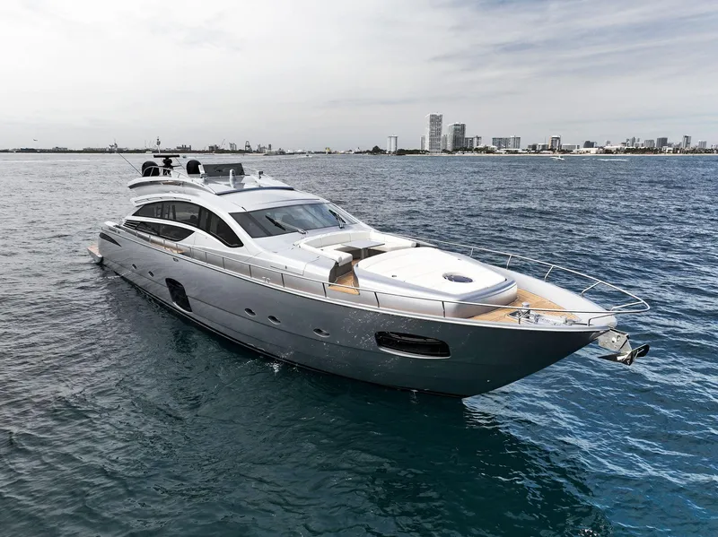 Slide: The Image of 2017 Pershing 82 VHP yacht cruising near a coastal city. - 16