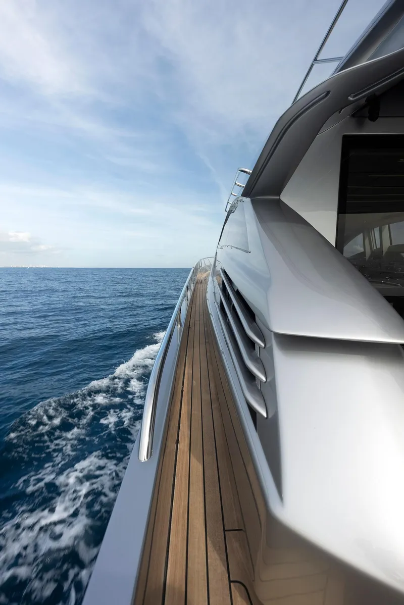 Slide: The Image of Side view of 2017 Pershing 82 VHP yacht cruising on the ocean. - 21