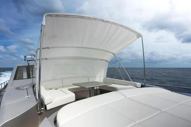 Slide: The Image of Luxurious 2017 Pershing 82 VHP yacht with shaded seating area on open sea. - 33