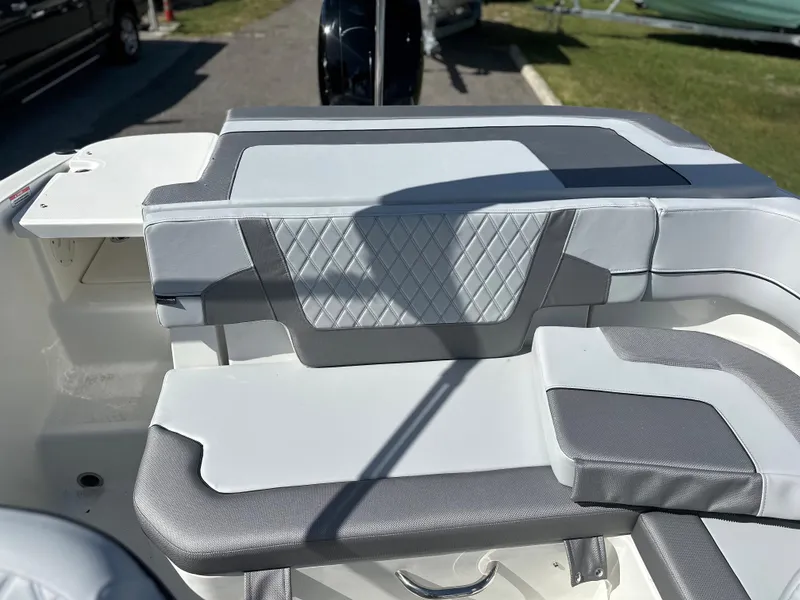 Slide: The Image of 2024 Bayliner VR5 Bowrider OB interior seating with gray and white upholstery. - 3