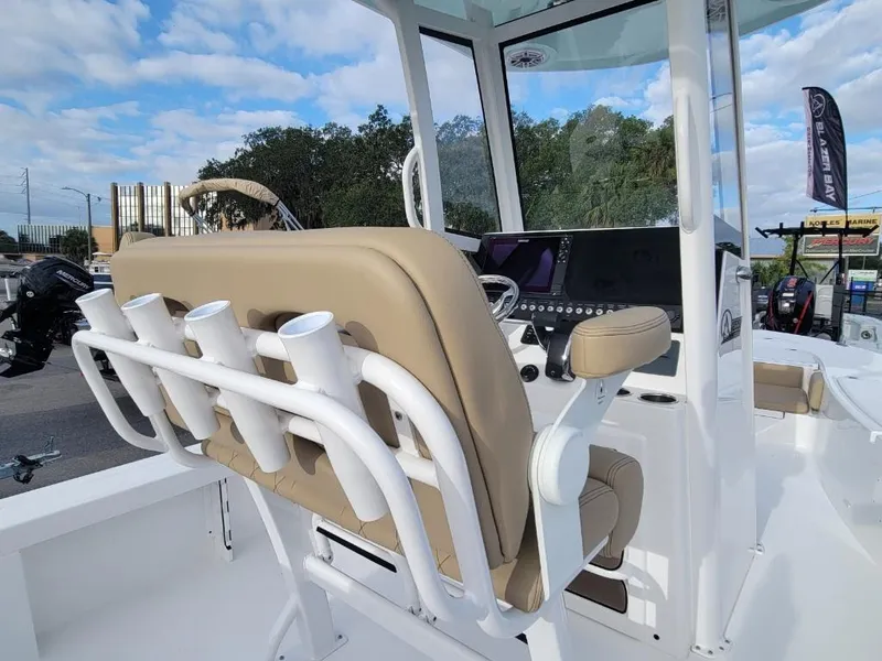 Slide: The Image of 2024 Blazer 2550 GTS boat interior with beige seating and rod holders. - 16