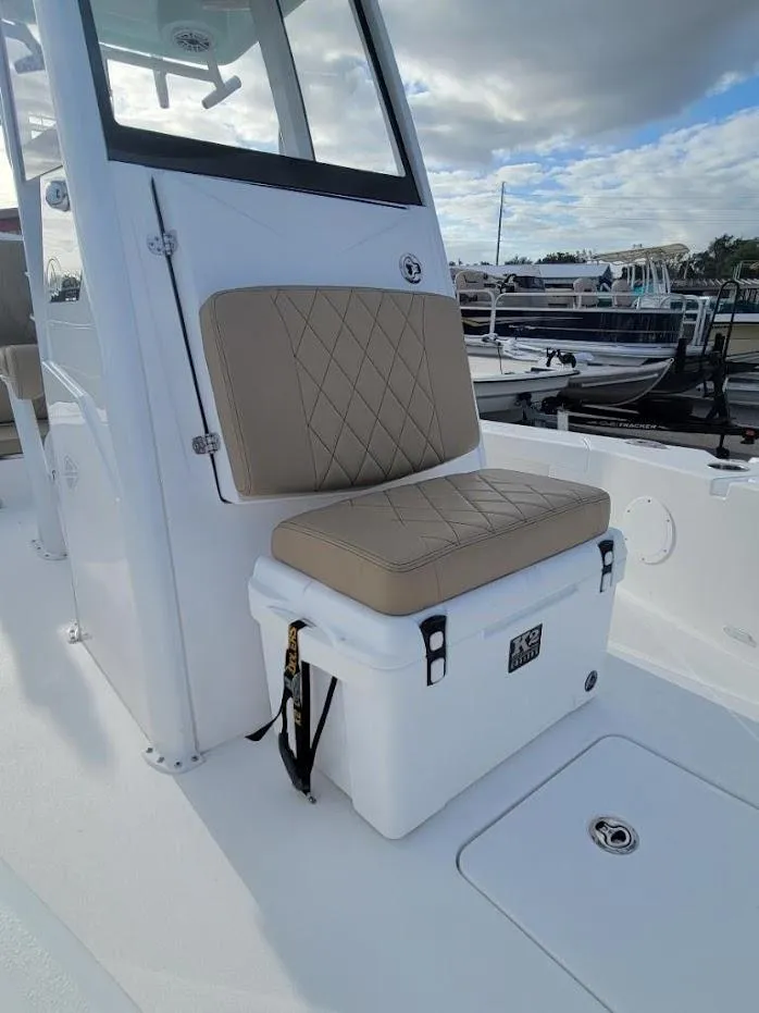 Slide: The Image of 2024 Blazer 2550 GTS boat with cushioned seating and cooler on deck. - 18